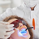 Dentist whitening a patient’s teeth in-office